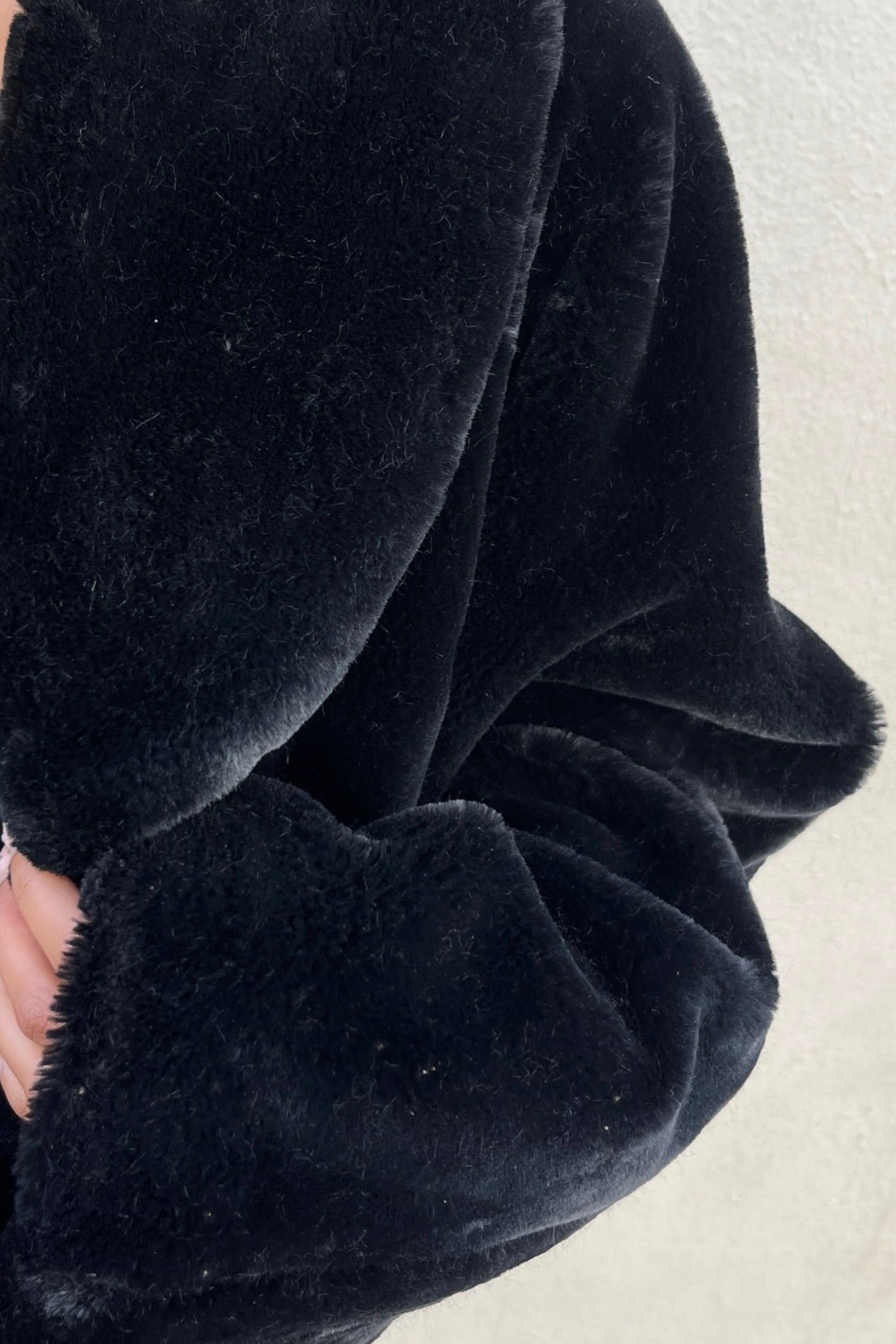 the black faux fur jacket
