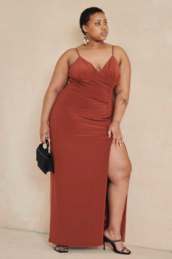 Vibrant and alluring, The Marigold Dress by Style Rotate is a celebration of modern elegance. Crafted from a stretchy jersey fabric, this dress features adjustable straps, ruching detail at the waist and back, and a thigh-high leg slit that adds a touch of allure. The silhouette flatters the figure, making it ideal for weddings, formal events, or any special occasion. Previously part of Style Rotate’s rental collection, this pre-loved piece is now available for purchase in size extra-large (UK16)