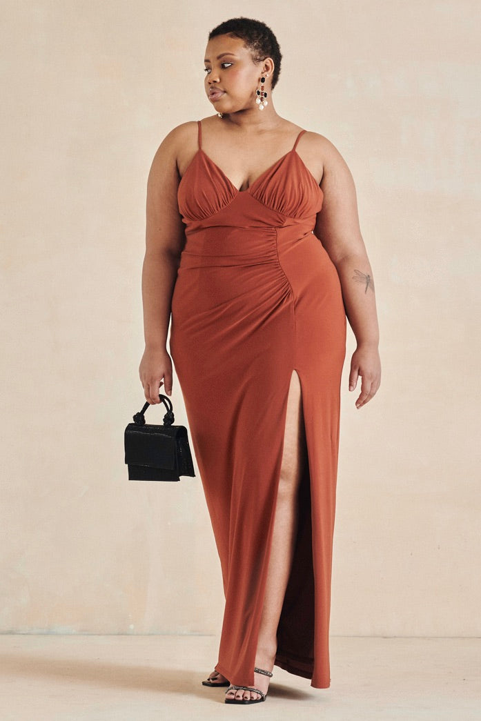 Vibrant and alluring, The Marigold Dress by Style Rotate is a celebration of modern elegance. Crafted from a stretchy jersey fabric, this dress features adjustable straps, ruching detail at the waist and back, and a thigh-high leg slit that adds a touch of allure. The silhouette flatters the figure, making it ideal for weddings, formal events, or any special occasion. Previously part of Style Rotate’s rental collection, this pre-loved piece is now available for purchase in size extra-large (UK16)