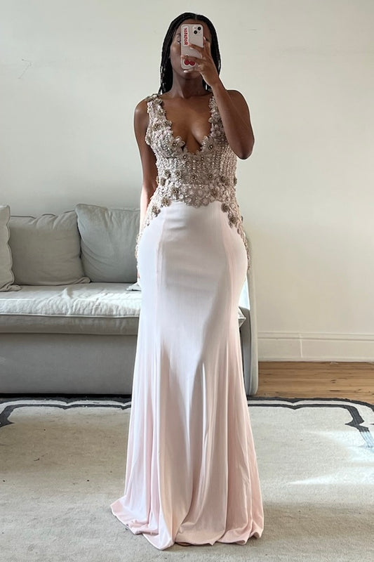 Blush pink mermaid gown with embellished bodice, deep V neckline, and open back.
