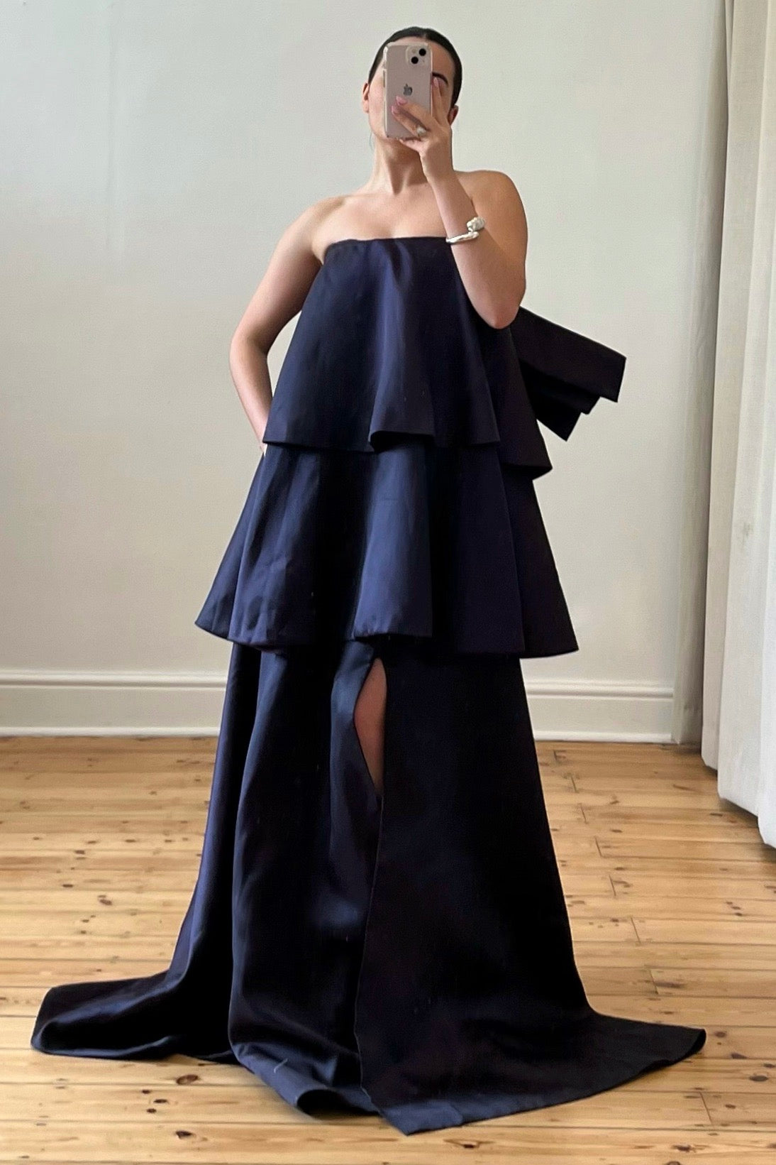 A front view of a strapless maxi gown