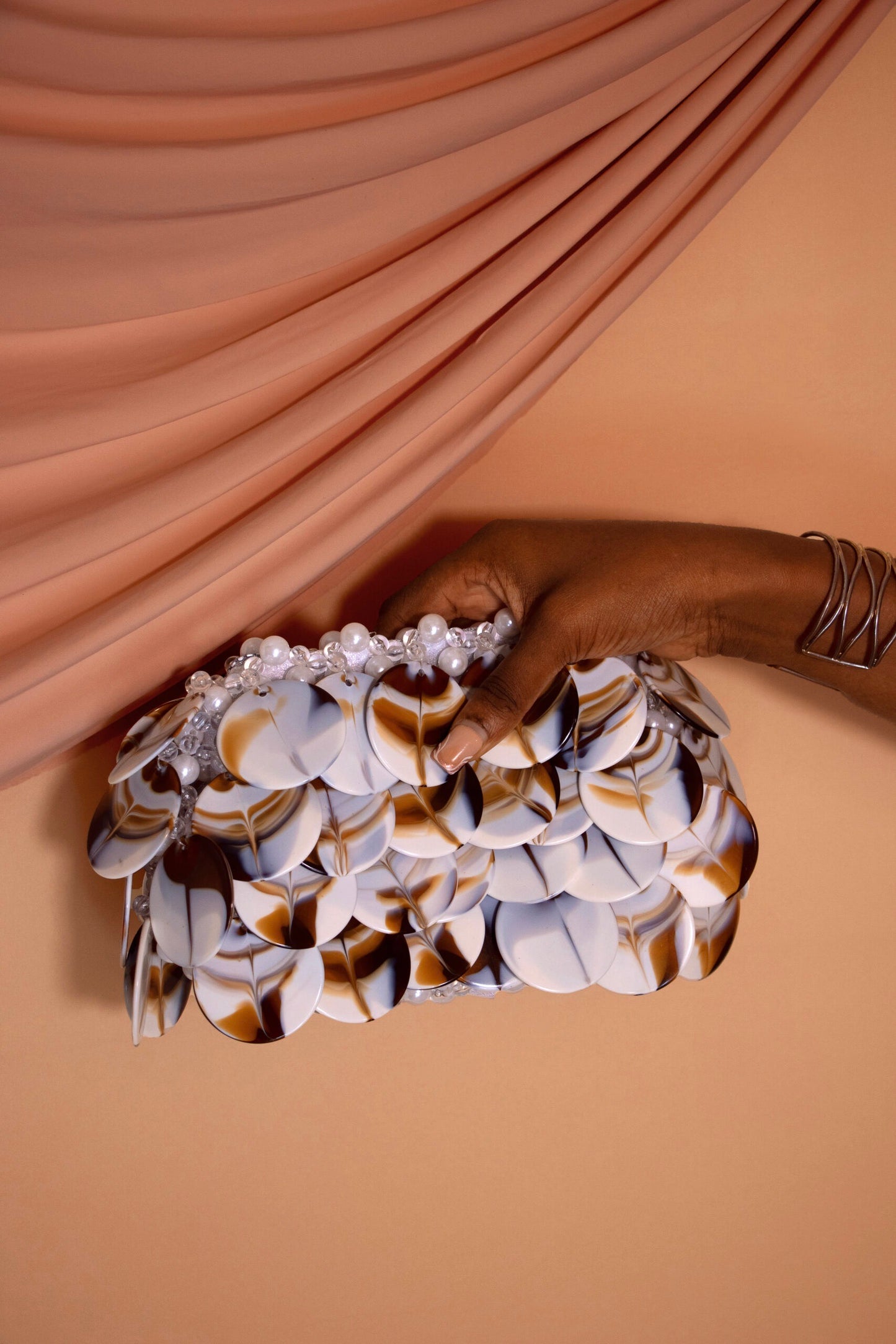 White beaded shell-style resort clutch bag, hand-held and handmade in Nigeria