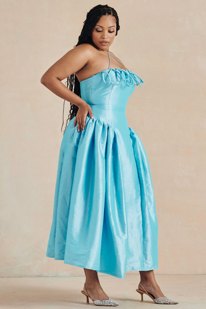 The Meraki Dress by Desirée Iyama in turquoise — eye-catching and playful designer rental for parties and high-impact occasions.