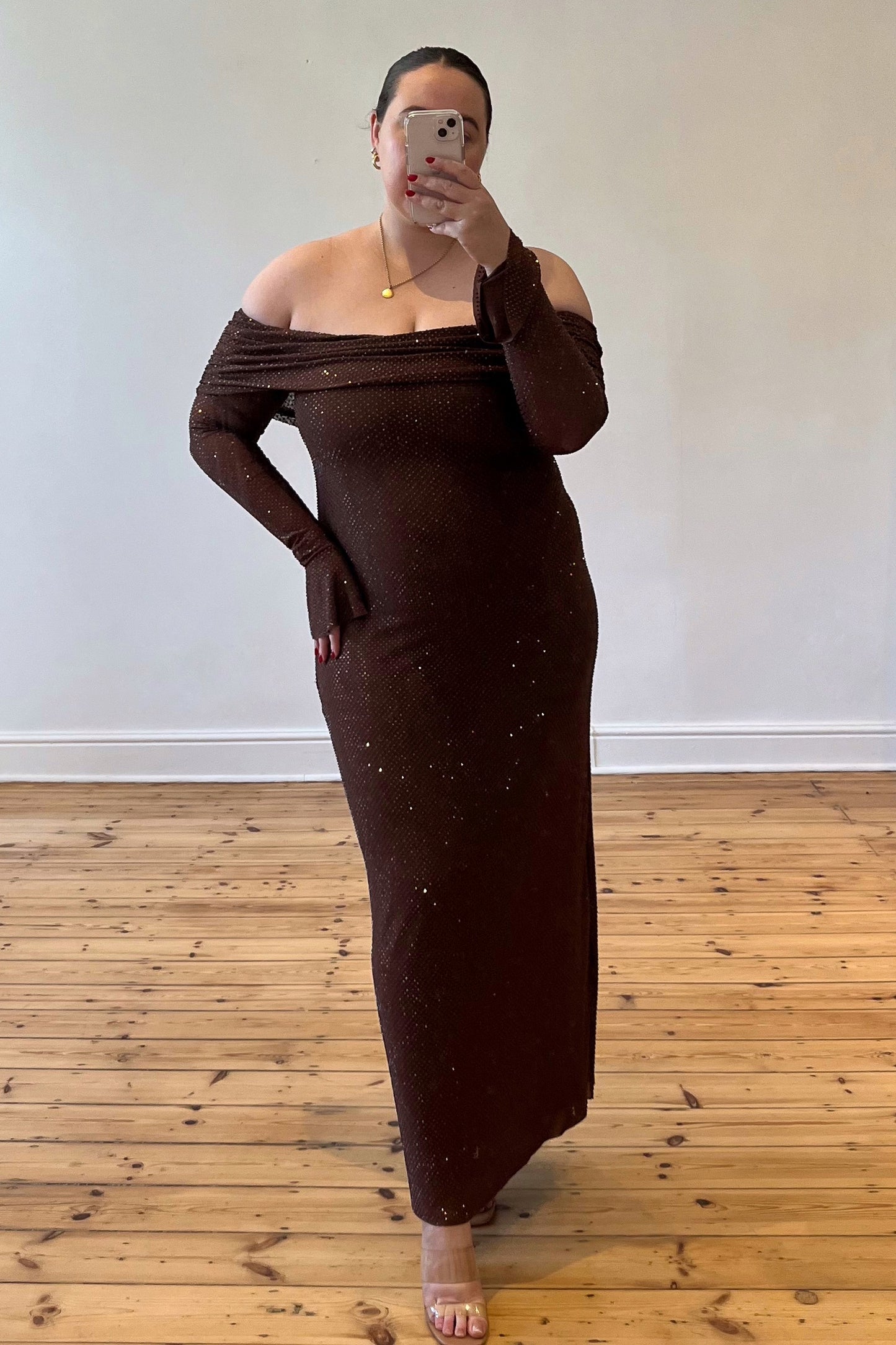 Meshki The Evelina Maxi in brown – a luxurious embellished gown with an off the shoulder neckline. Elegant, flattering, and available for rental now.