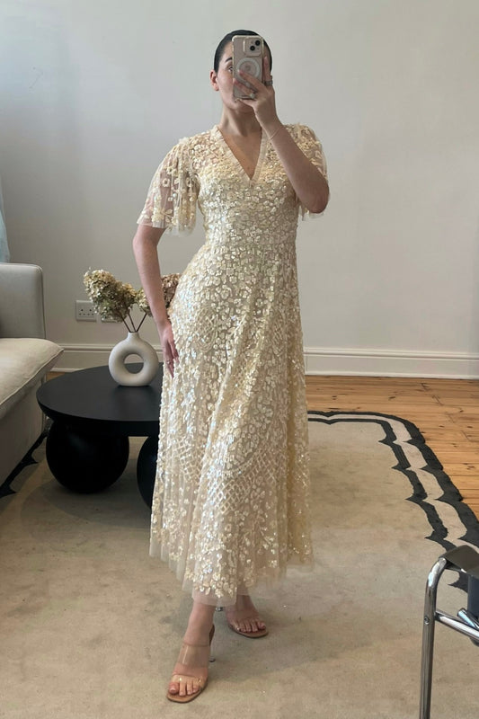 The Ella Dress by Needle & Thread – an off-white midi dress with sequin and beaded embellishments, perfect for weddings and gala dinners. Elegant, timeless, and available now for rental.
