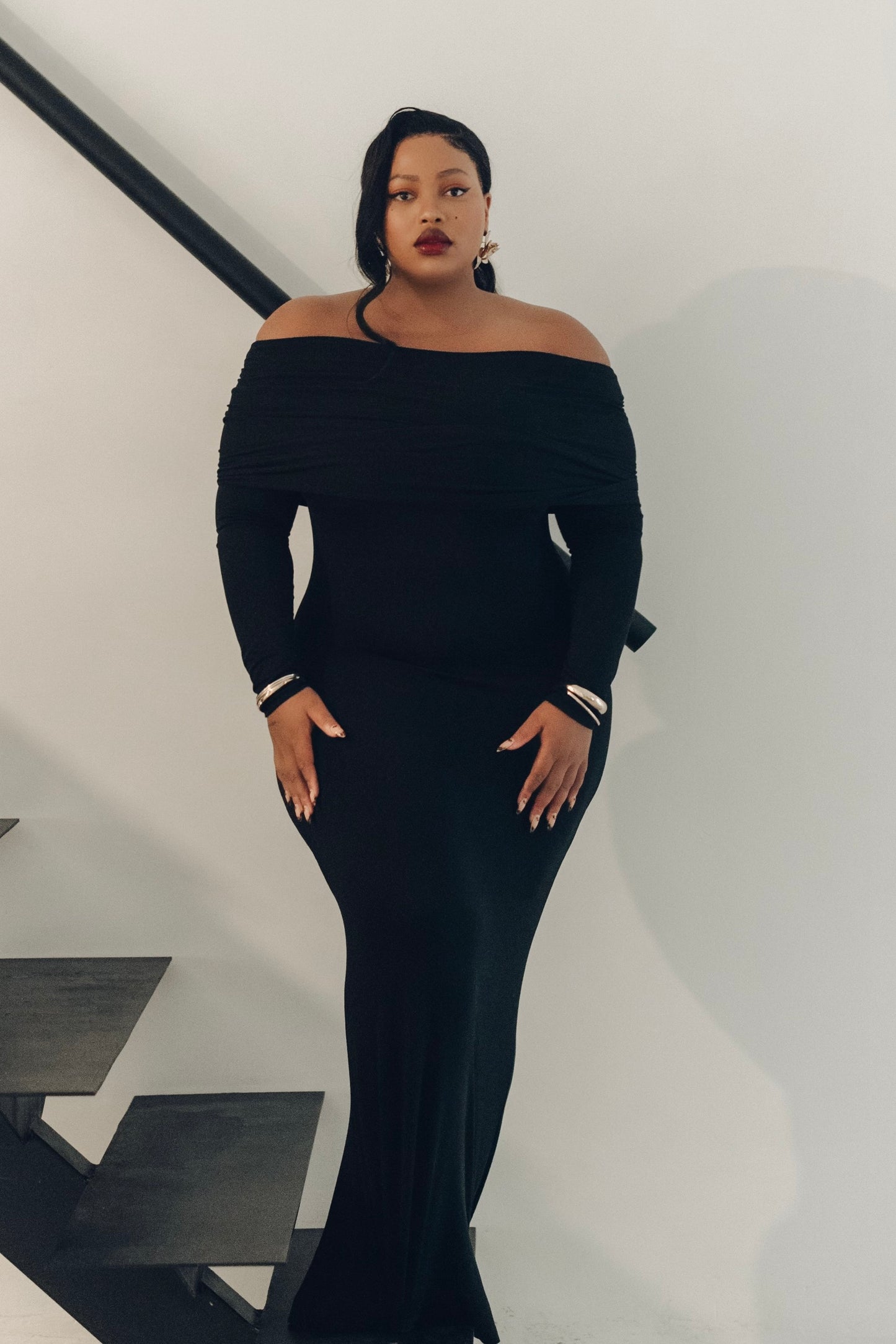 The Lily Maxi Gown by Rethread – a sleek off-the-shoulder black long-sleeve gown perfect for black-tie events. Refined, timeless, and available now.