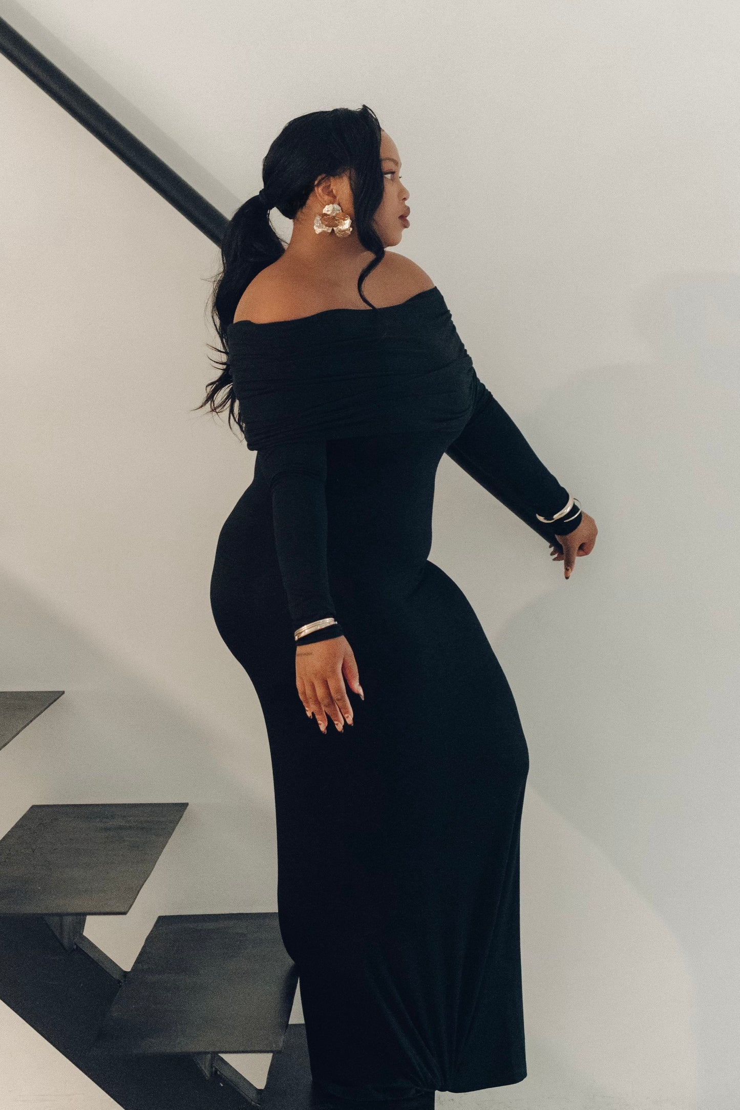 The Lily Maxi Gown by Rethread – a sleek off-the-shoulder black long-sleeve gown perfect for black-tie events. Refined, timeless, and available now.