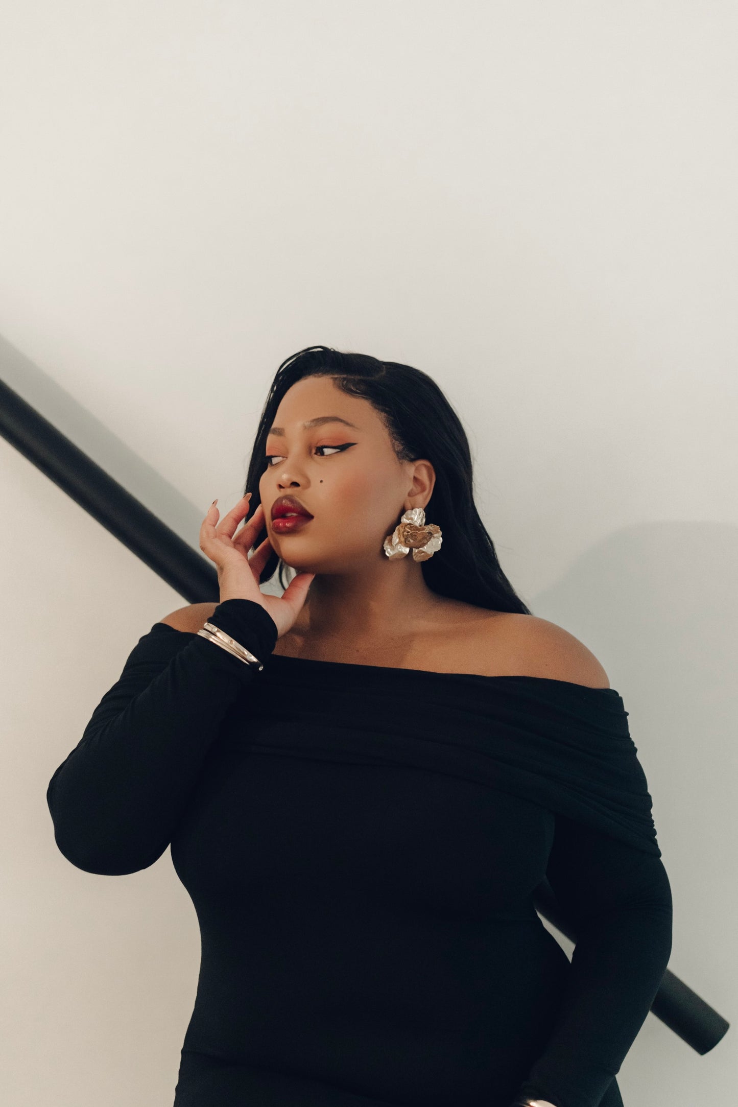 The Lily Maxi Gown by Rethread – a sleek off-the-shoulder black long-sleeve gown perfect for black-tie events. Refined, timeless, and available now.