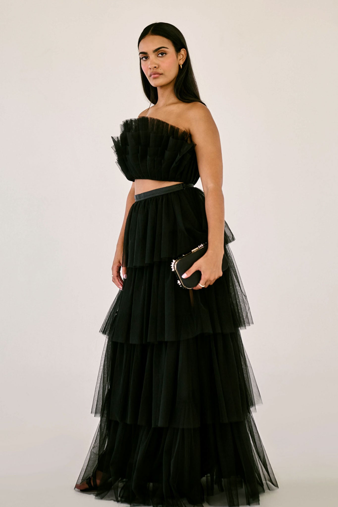 The Odessa Skirt by SR | Poetry – a tiered black tulle skirt with a sultry front slit, perfect for formal occasions. Elegant, timeless, and available now.