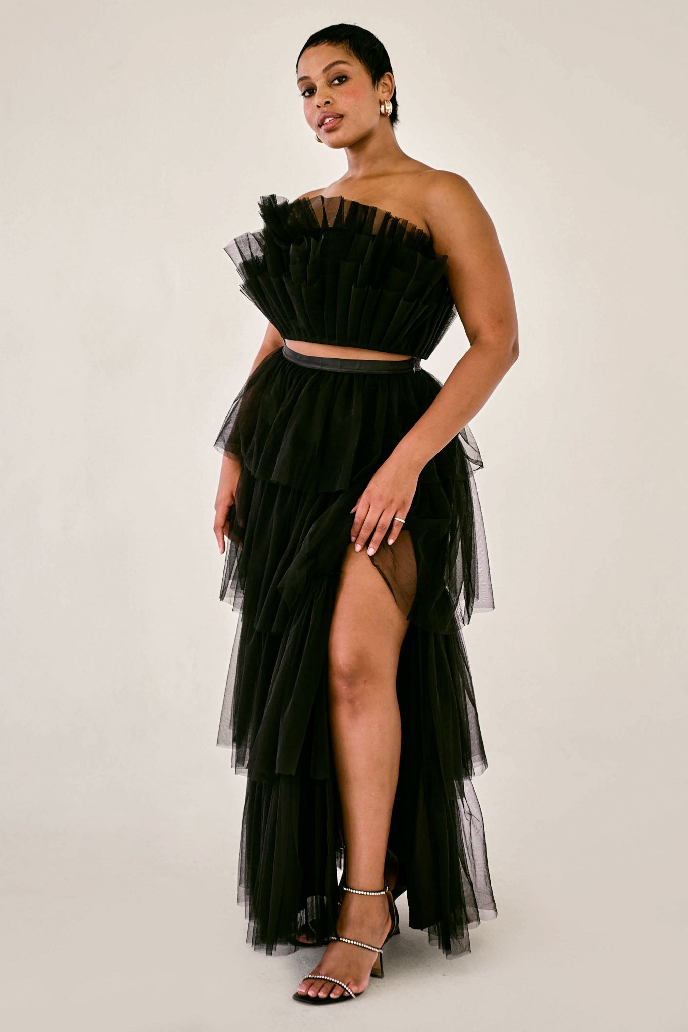 The Odessa Skirt by SR | Poetry – a tiered black tulle skirt with a sultry front slit, perfect for formal occasions. Elegant, timeless, and available now.