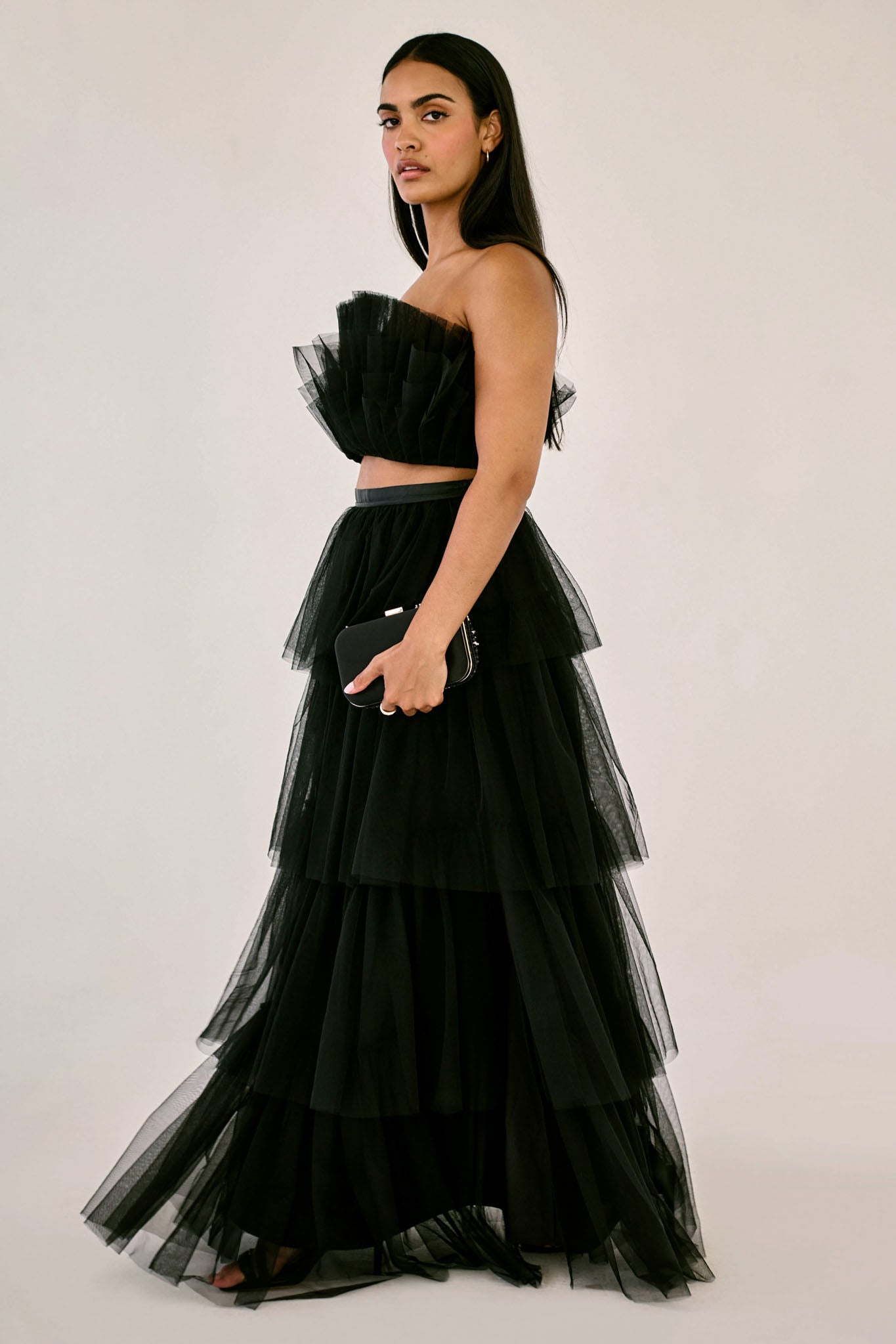 The Odessa Skirt by SR | Poetry – a tiered black tulle skirt with a sultry front slit, perfect for formal occasions. Elegant, timeless, and available now.