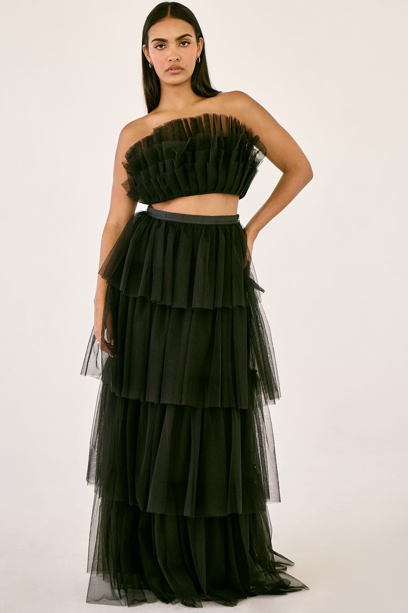 The Odessa Skirt by SR | Poetry – a tiered black tulle skirt with a sultry front slit, perfect for formal occasions. Elegant, timeless, and available now.