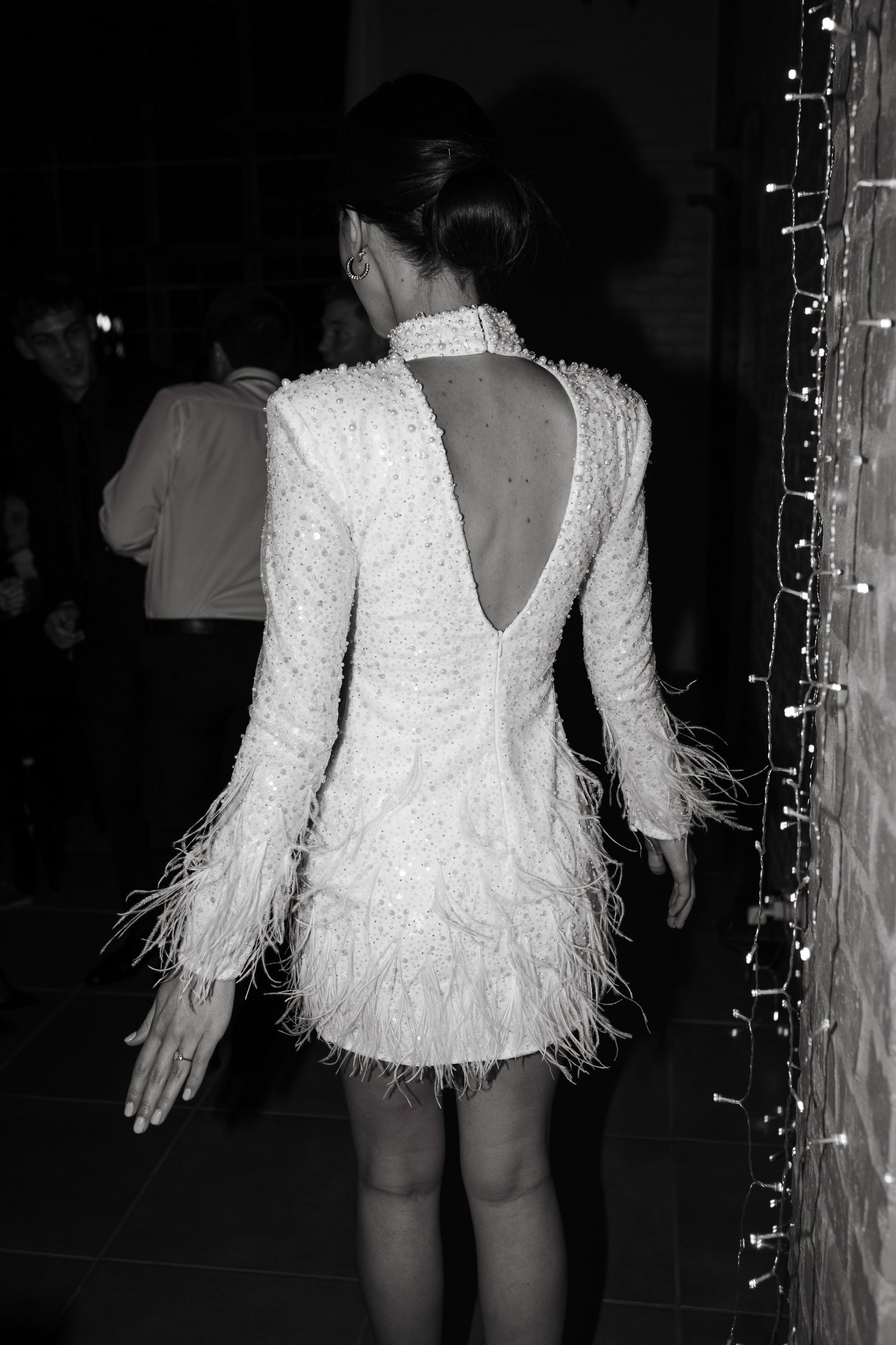 The Kent Mini by Stephen Van Eeden – a white mini dress featuring intricate beading and ostrich feather details, ideal for formal occasions.