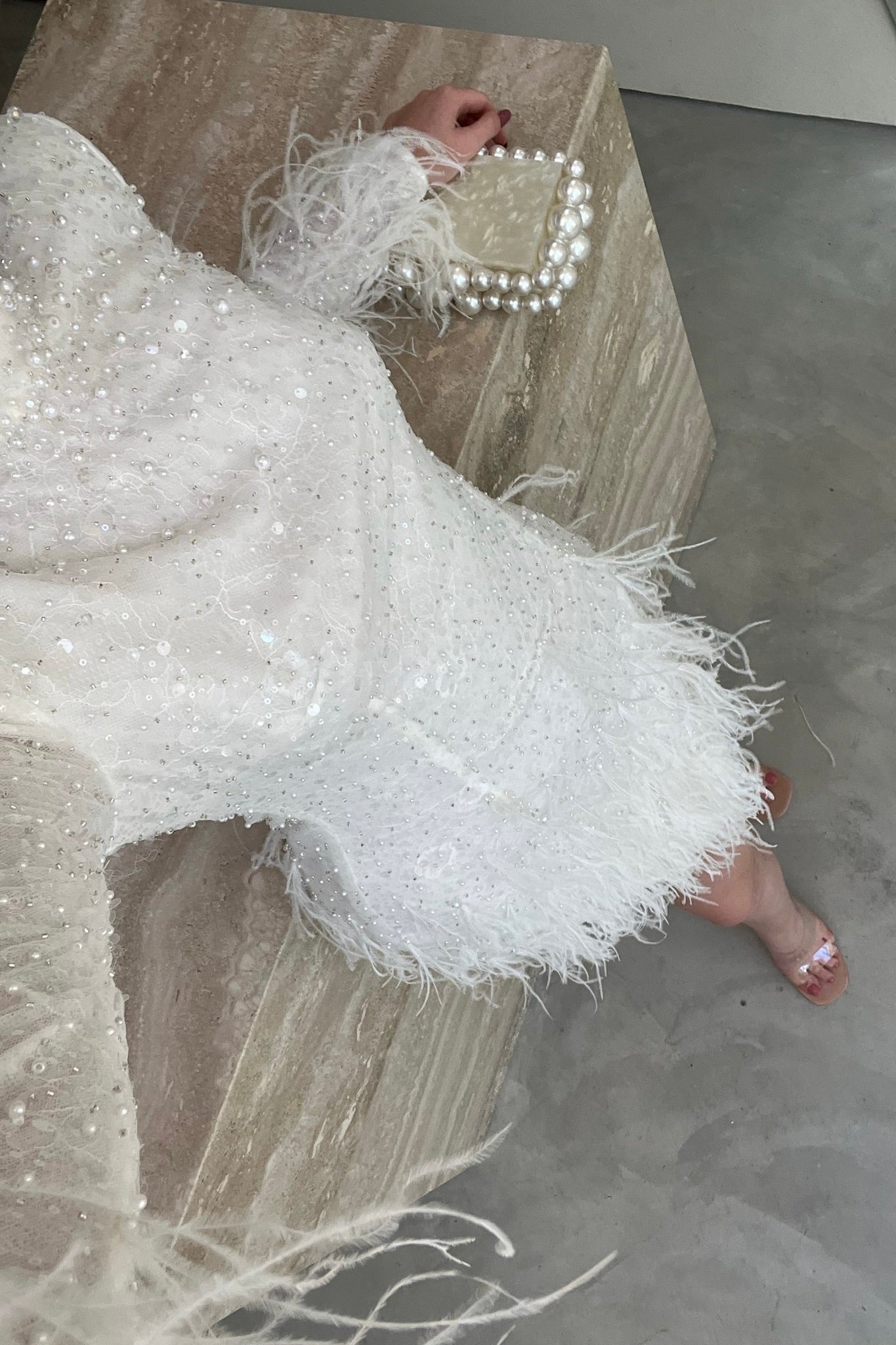 The Kent Mini by Stephen Van Eeden – a white mini dress featuring intricate beading and ostrich feather details, ideal for formal occasions.