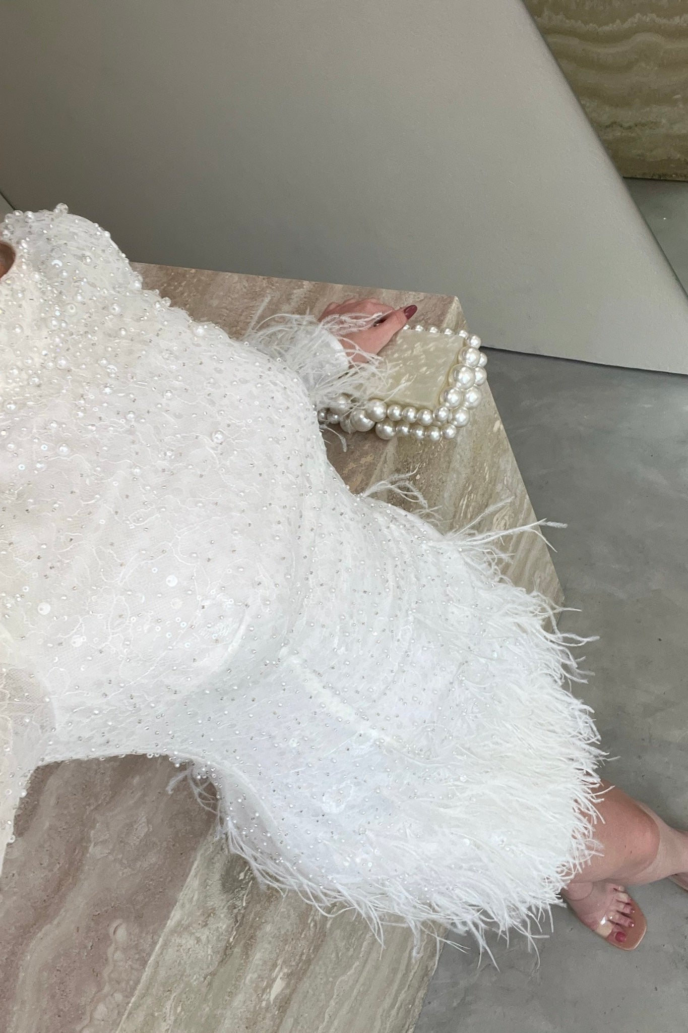 The Kent Mini by Stephen Van Eeden – a white mini dress featuring intricate beading and ostrich feather details, ideal for formal occasions.