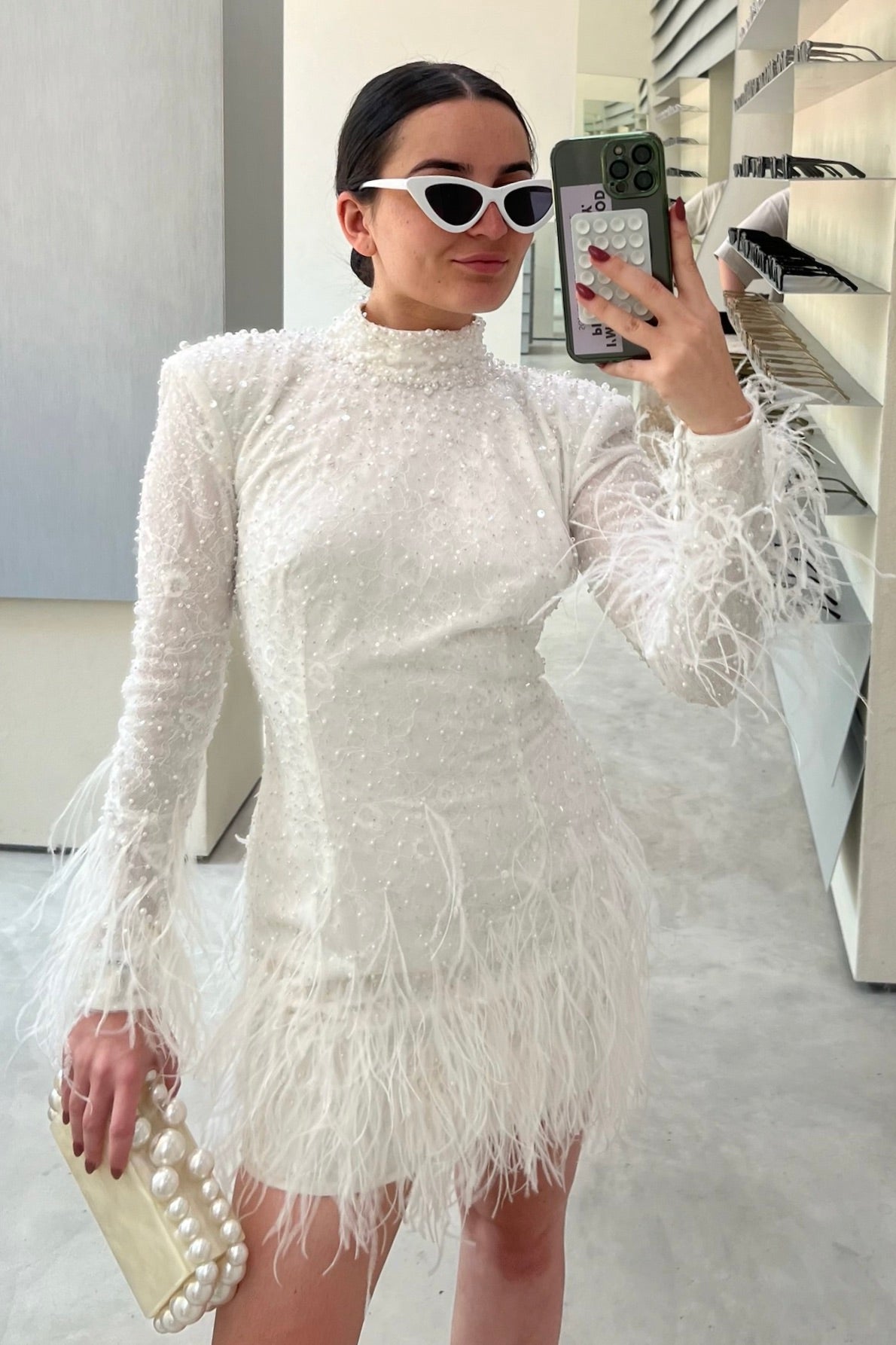 The Kent Mini by Stephen Van Eeden – a white mini dress featuring intricate beading and ostrich feather details, ideal for formal occasions.