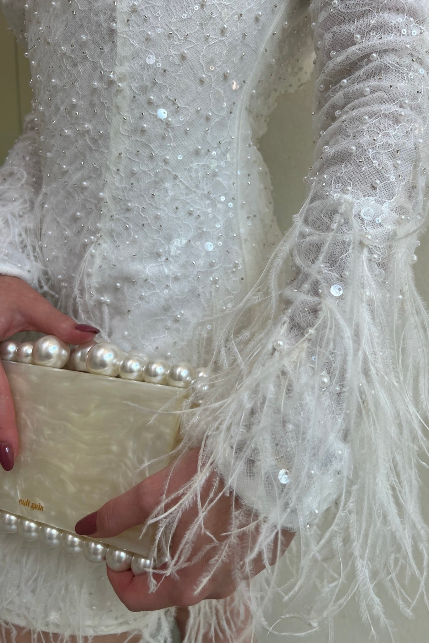 The Kent Mini by Stephen Van Eeden – a white mini dress featuring intricate beading and ostrich feather details, ideal for formal occasions.