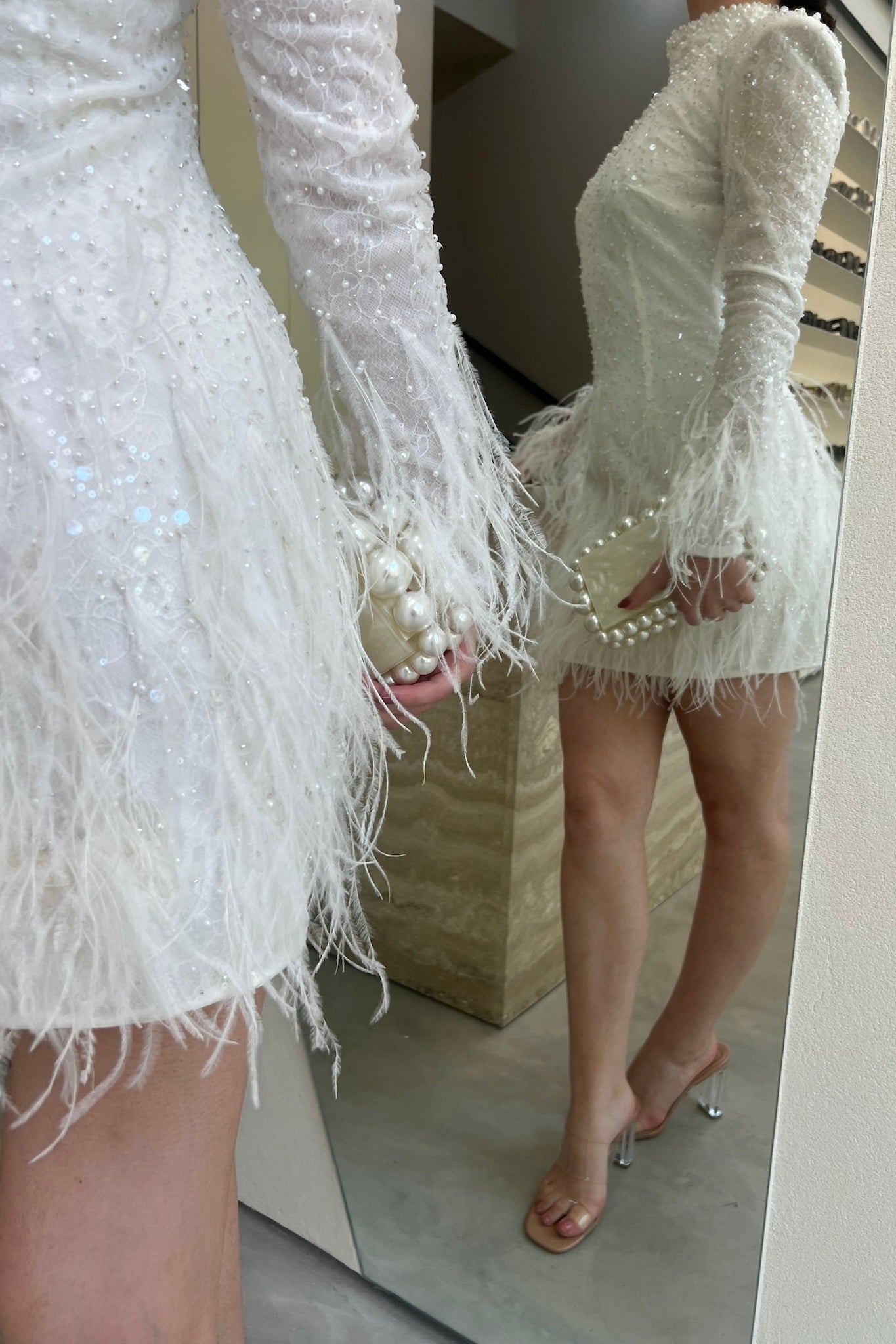 The Kent Mini by Stephen Van Eeden – a white mini dress featuring intricate beading and ostrich feather details, ideal for formal occasions.