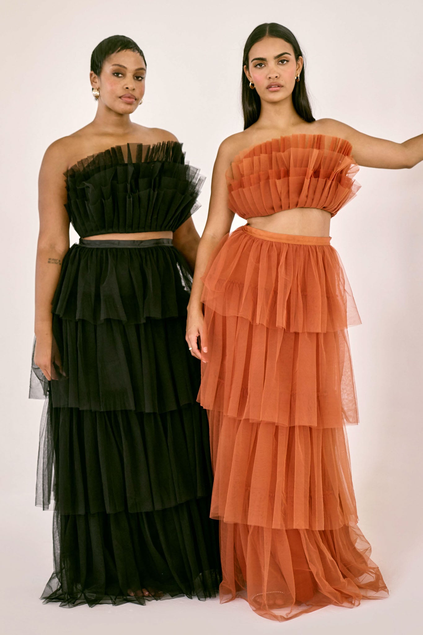 The Odessa Skirt by SR | Poetry – a dramatic rust tiered tulle skirt with a sultry front slit, perfect for formal occasions. Elegant, timeless, and available now.