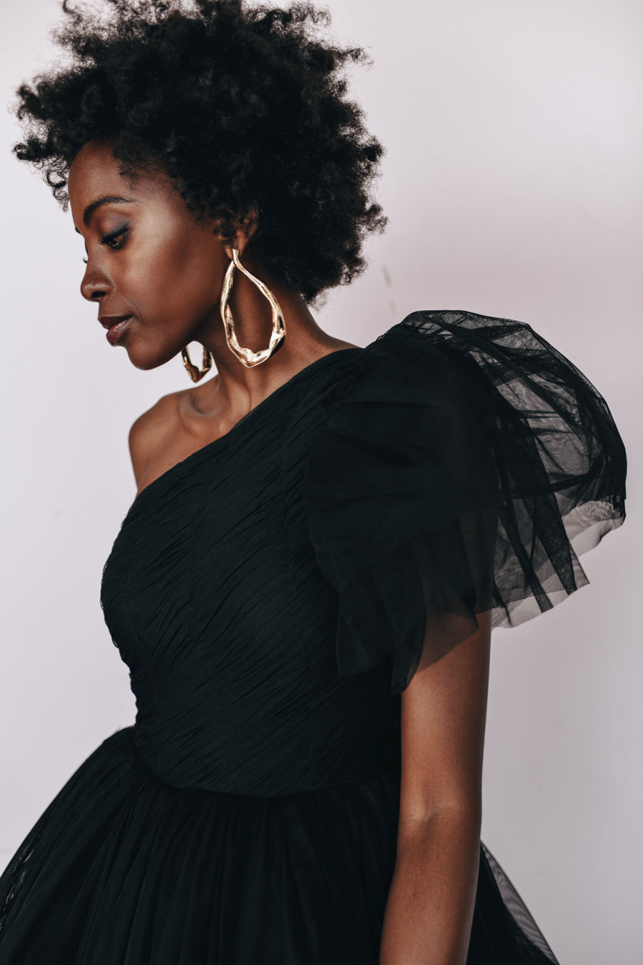 Lace & Beads The Harley Gown in black, one-shoulder tulle evening gown available for rental.