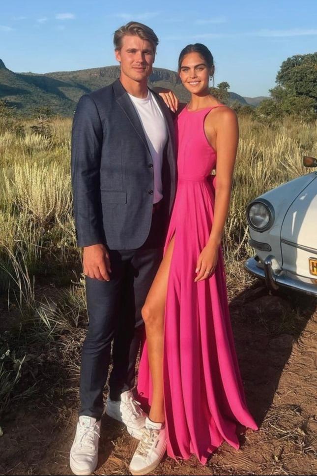 Elevate your formal look with The Mary-Kate Dress, a custom-designed hot pink satin gown featuring a low back, removable bow, and side slit. Perfect for weddings and black-tie events. Rent now from Style Rotate.