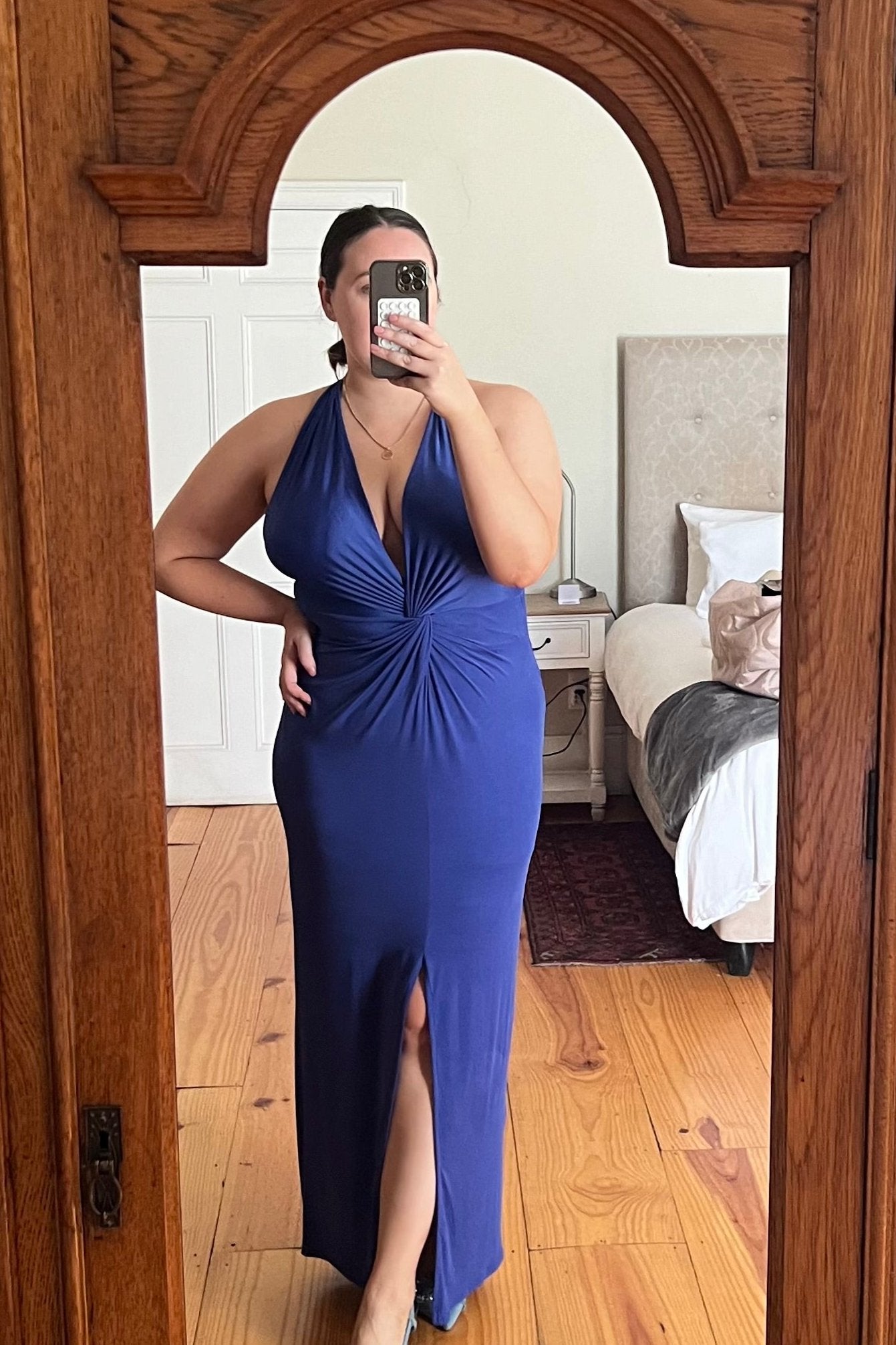 Cobalt-blue halter-neck maxi dress with front twist detail and thigh-high slit, perfect for formal occasions or evening events