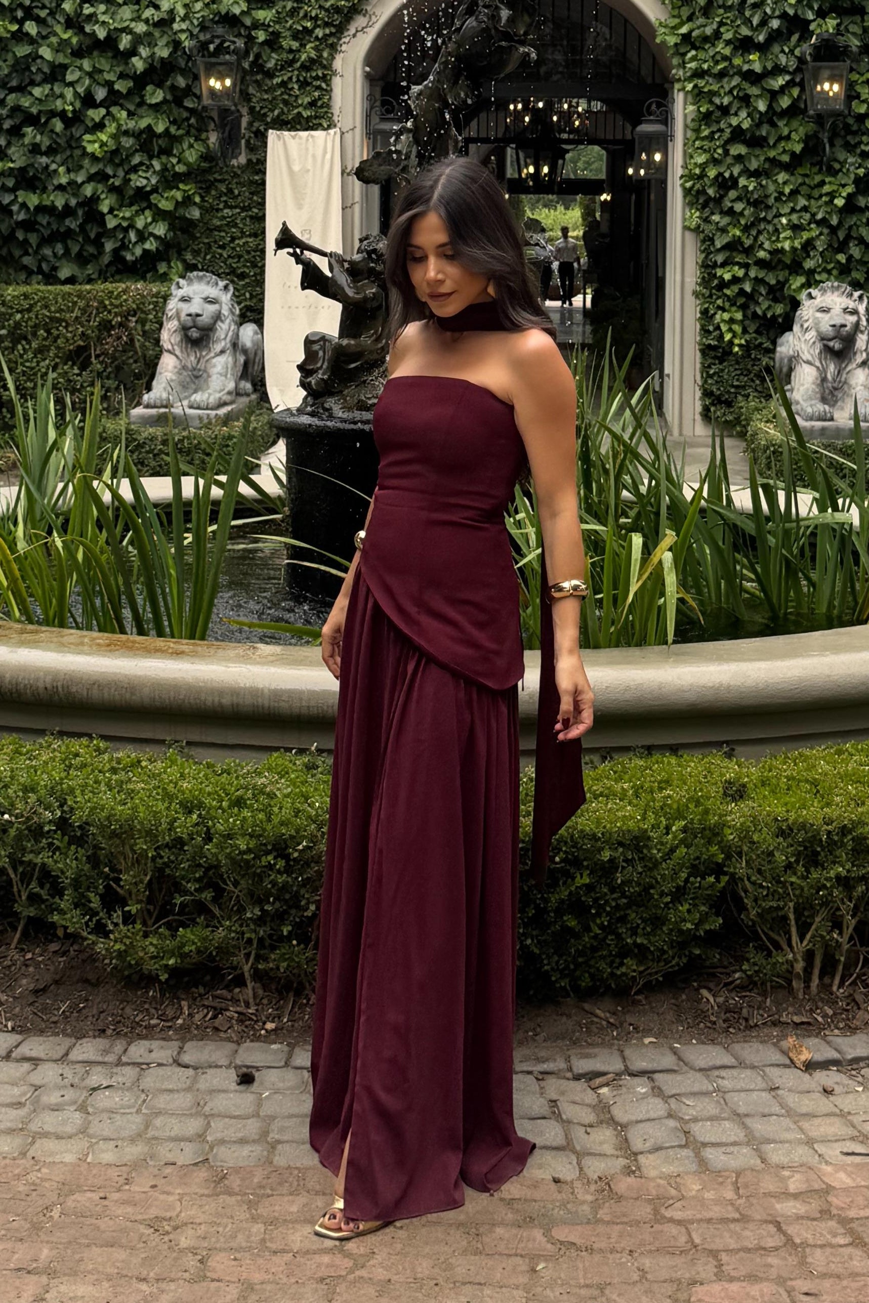 evening dress rental cherry dress styled outdoors near fountain