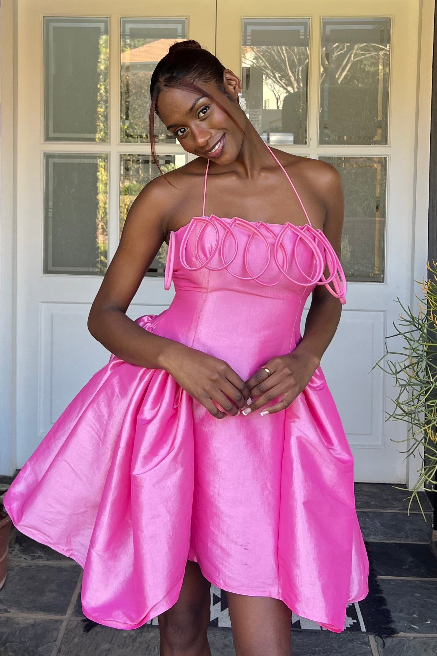 The Meraki Mini Dress by Desirée Iyama in pink - a  vibrant occasionwear rental piece perfect for birthdays and special events.