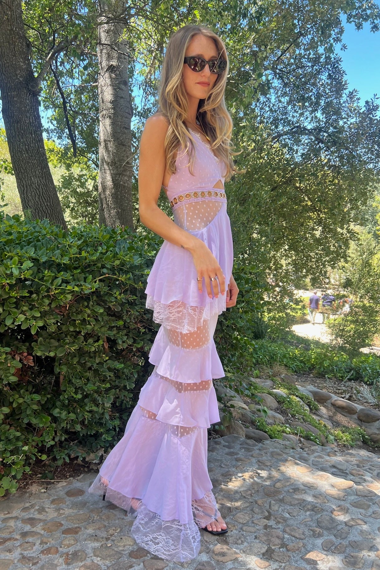 Lilac lace and chiffon floor-length gown with mesh waist inserts and gold O-ring details, pre-loved and available for resale as elegant sustainable occasionwear.