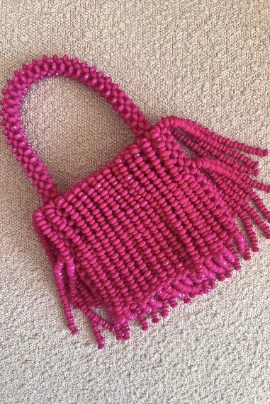 Bright pink mini beaded fringe bag, hand-held and handmade in Africa