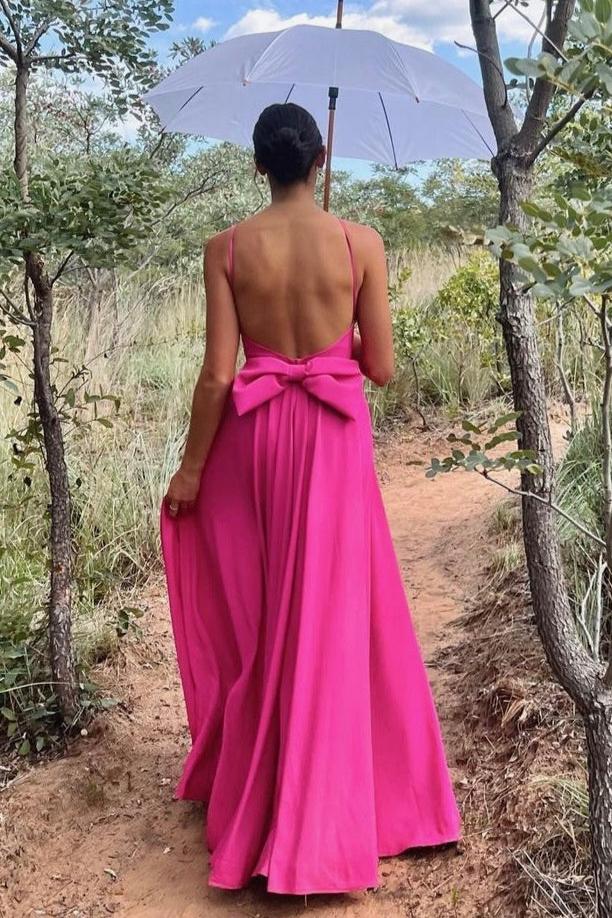  Elevate your formal look with The Mary-Kate Dress, a custom-designed hot pink satin gown featuring a low back, removable bow, and side slit. Perfect for weddings and black-tie events. Rent now from Style Rotate.